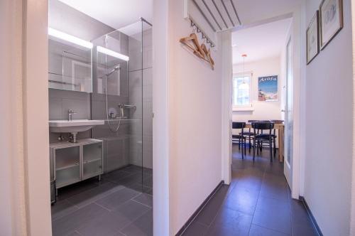 a bathroom with a shower and a sink at Viktoria B42 by Arosa Holiday in Arosa