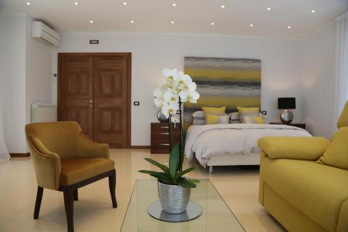 a bedroom with a bed and a couch and a chair at Villa Panorama in Oratino