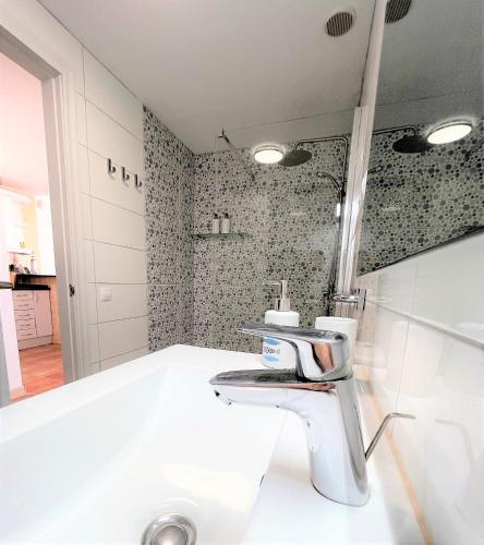 a bathroom with a sink and a mirror at Salitre Ocean Sunset in El Cotillo