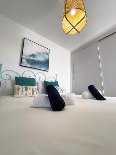 a bedroom with a bed with two pillows on it at Salitre Ocean Sunset in El Cotillo