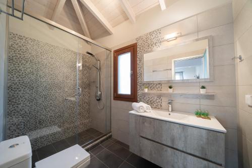 a bathroom with a sink and a shower and a toilet at Villa Cleopatra Fiskardo in Fiskardho