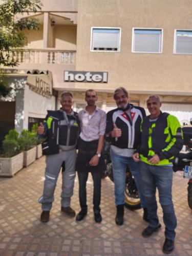 a group of men standing in front of a hotel at Hôtel Imilchil in Midelt