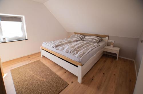 a small bedroom with a bed and a window at ALM-Stube in Füssen