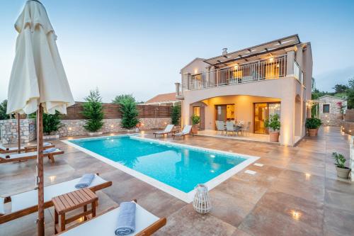 a swimming pool in the backyard of a house at Villa Cleopatra Fiskardo in Fiskardho