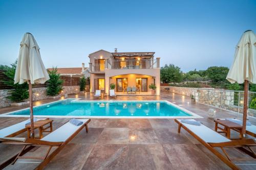 a villa with a swimming pool and a house at Villa Cleopatra Fiskardo in Fiskardho