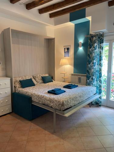 a bedroom with a large bed with blue walls at Porta Romana Bella in Milan