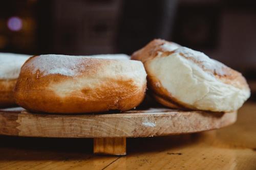 two loaves of bread sitting on a wooden cutting board at Rtanj Kopaonik Eco Resort & Spa in Kopaonik
