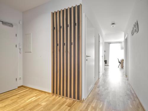 a hallway with white walls and a wooden partition at Sunlodge Oeblarn Top B1 Schladming-Dachstein in Öblarn