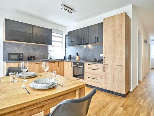 a kitchen with a wooden table and chairs at Sunlodge Oeblarn Top B1 Schladming-Dachstein in Öblarn