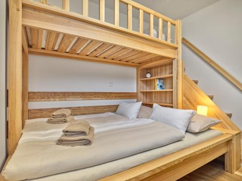 a wooden bunk bed with two towels on it at Sunlodge Oeblarn Top B1 Schladming-Dachstein in Öblarn