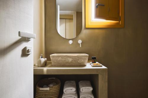 a bathroom with a sink and a mirror at Elaia Luxury Suites Mykonos in Mýkonos City