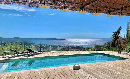 a swimming pool with a view of the ocean at Découvrez la Villa « The View » in Cavalaire-sur-Mer