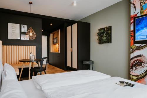 a bedroom with a bed, chair, table and a television at Rioca Vienna Posto 2 in Vienna