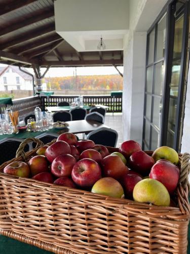 a basket of apples sitting on a table at Livada Bucovinei in Horodnic de Sus