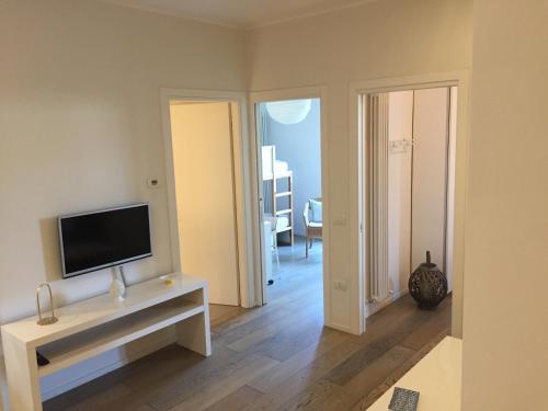 a living room with a flat screen tv on a table at Suite Mare Centro in Pesaro