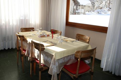 a table in a restaurant with a white table cloth at Hotel Cristallo in Macugnaga
