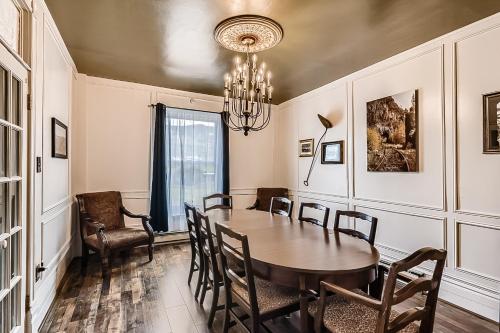 a dining room with a table and chairs and a chandelier at The Conductor's House in Cripple Creek