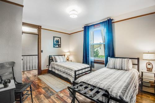 a bedroom with two beds and a window at The Conductor's House in Cripple Creek