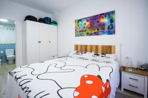 a bedroom with a bed with a red fish on it at Saras in Les Cases d'Alcanar