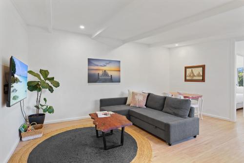 a living room with a couch and a table at Snapper Unit 4 in Point Lookout