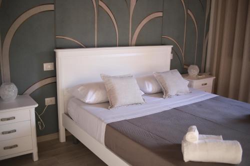 a bedroom with a bed with white sheets and pillows at La Dimora del Croccio - Gole del Calore in Felitto