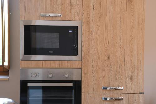 a kitchen with a microwave and a stove at La Dimora del Croccio - Gole del Calore in Felitto