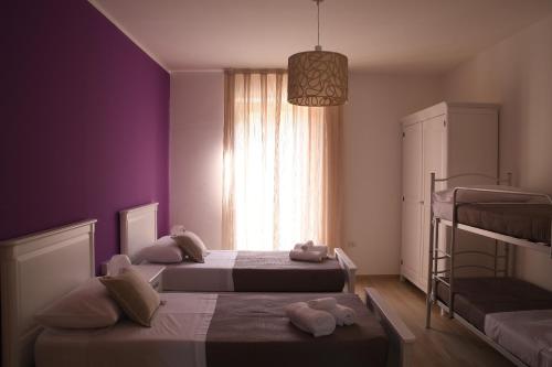 a bedroom with two beds and a window at La Dimora del Croccio - Gole del Calore in Felitto