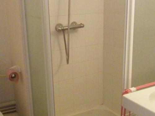 a shower in a bathroom with a glass door at Appartement Mont-Dore, 2 pièces, 4 personnes - FR-1-415-8 in Le Mont-Dore