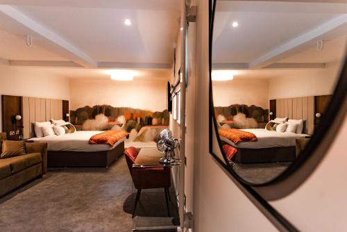 a hotel room with two beds and a mirror at Lace Market Hotel in Nottingham