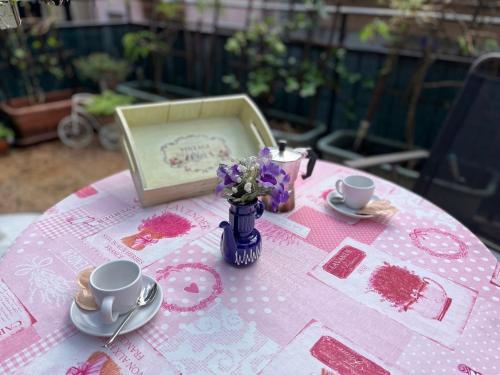SueglioにあるCasa Elenaの花瓶付きピンクのテーブルクロス付きテーブル