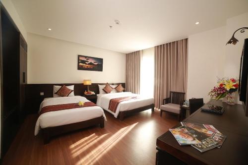 Edele Hotel Nha Trang Beachにあるベッド
