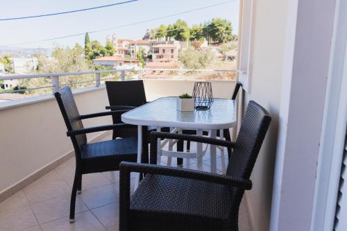 a table and chairs on a balcony with a view at Sunday Apartments in Nafplio