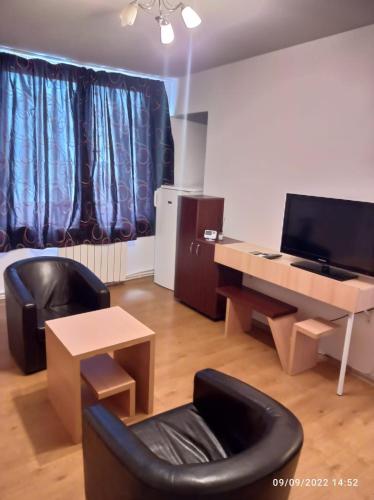 a living room with a desk and a chair at Central Best cozy in in Bucharest