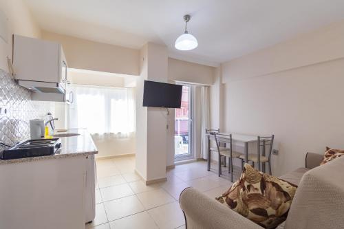 a kitchen and living room with a couch and a table at Apartments Near to City Center and Beach in Marmaris