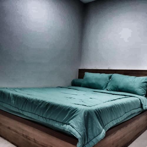 a bedroom with a bed with blue sheets at SLEPTOPIA at Formosa Residence - Apartment 70m2 with Best interior & View in town in Nagoya