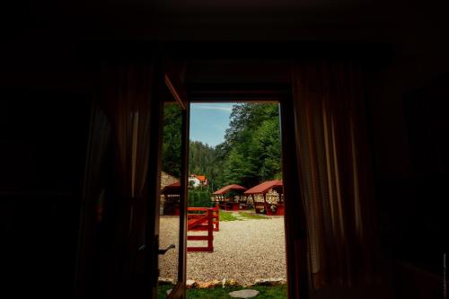 an open door with a view of a playground at Casa Cheile Dâmbovicioarei - Cabana 2 in Dîmbovicioara