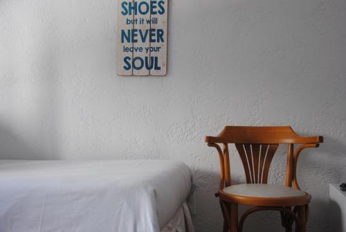 a bedroom with a wooden chair next to a bed at Blu Inn in Punta del Este