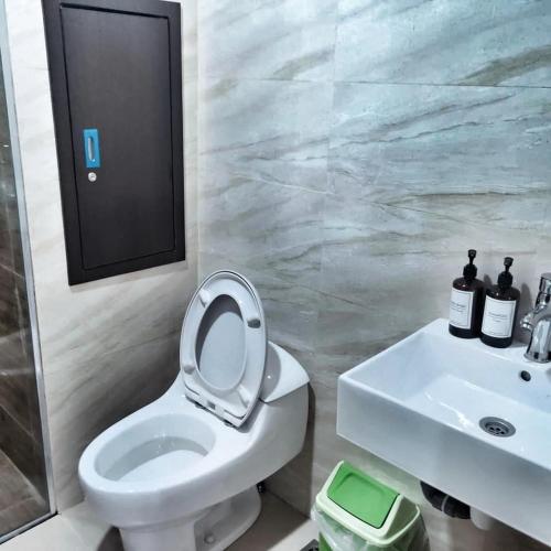 a bathroom with a toilet and a sink at SLEPTOPIA at Formosa Residence - Apartment 70m2 with Best interior & View in town in Nagoya
