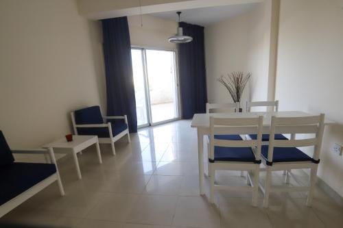 a dining room with a white table and chairs at Larnaca Center Apartments in Larnaca