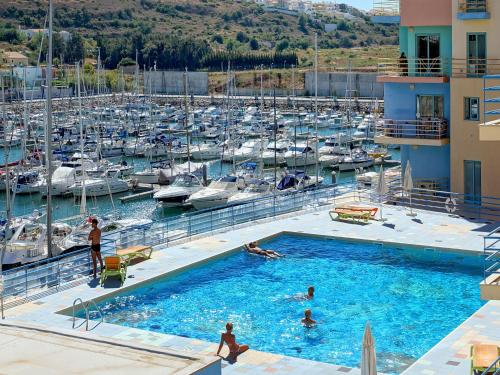 a group of people in a swimming pool in a marina at Marina Sea Residence in Albufeira