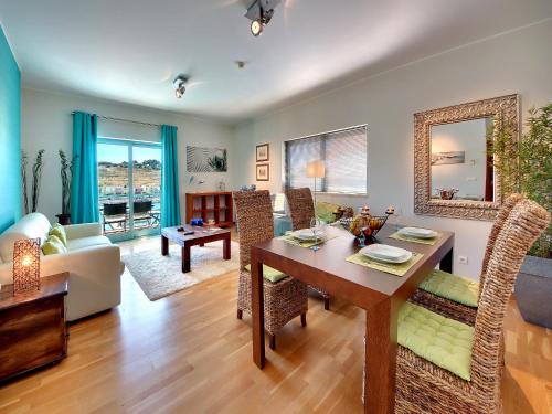 a dining room and living room with a table at Marina Sea Residence in Albufeira