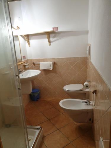 a bathroom with two toilets and a sink at Residence Luna Rossa in Costa Rei