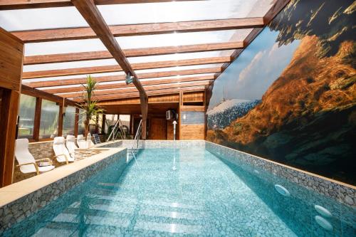 a swimming pool in a house with a mountain view at Penzion Stonozka in Ludvíkov