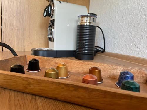 a wooden tray with different colored cups on a table at Hopfenglück in Tettnang