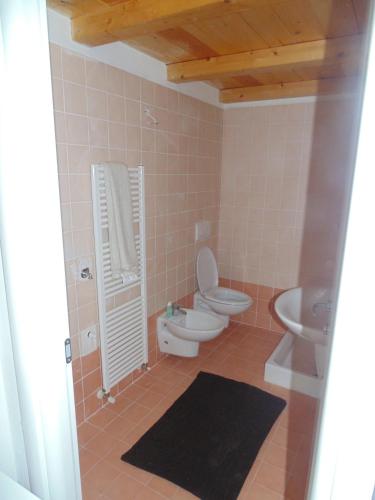 a bathroom with a toilet and a sink at Cà Del Polsèt in Brenzone sul Garda