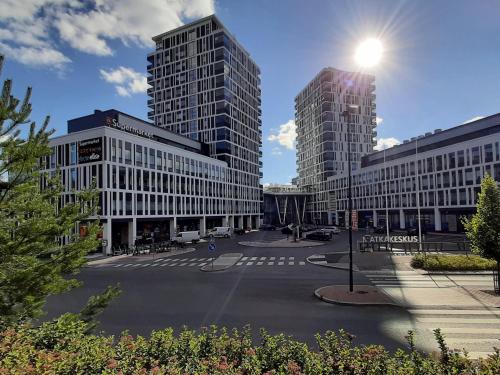 a street with two tall buildings in a city at City Apartment with lake view and free parking in Kuopio