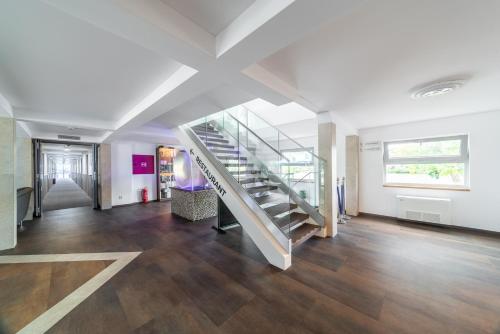 an empty hallway with a staircase in a house at Botel Racek in Prague