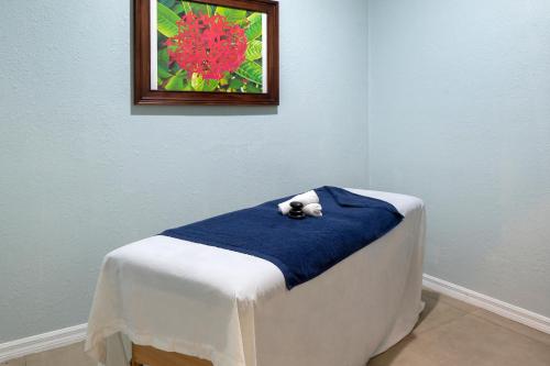 a teddy bear laying on a blue blanket on a bed at Viva Fortuna Beach by Wyndham, A Trademark All Inclusive in Freeport