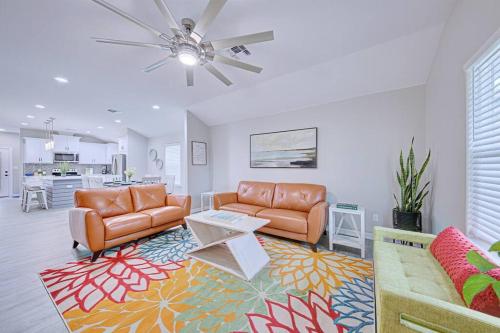 a living room with two couches and a table at 2022 Built Modern Family-Friendly Oasis in Corpus Christi