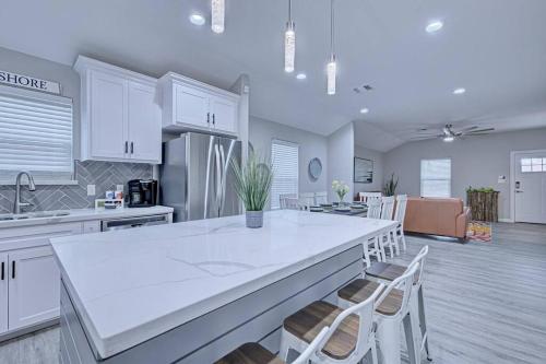 a kitchen with a large white island in a room at 2022 Built Modern Family-Friendly Oasis in Corpus Christi